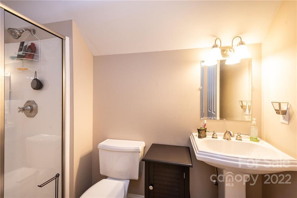4597 Hickory Nut Ridge Road Granite Falls, NC 28630 - Photo 37 of 48 a bathroom with a sink a toilet and shower