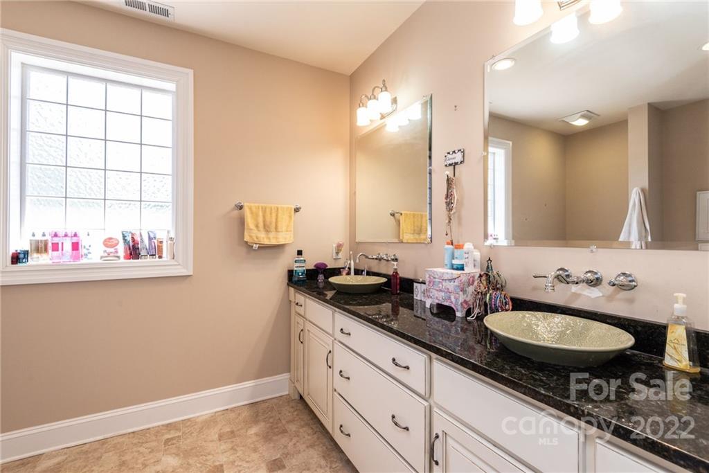 4597 Hickory Nut Ridge Road Granite Falls, NC 28630 - Photo 42 of 48 a bathroom with double vanity sink and a mirror