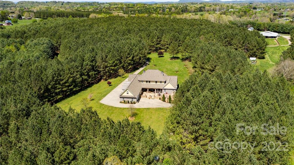 4597 Hickory Nut Ridge Road Granite Falls, NC 28630 - Photo 45 of 48 a view of a house with a yard and large trees