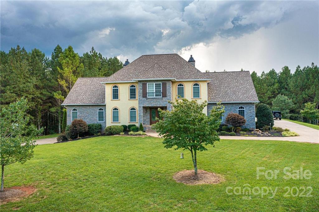 4597 Hickory Nut Ridge Road Granite Falls, NC 28630 - Photo 48 of 48 a house that has a big yard and a fountain in front of it