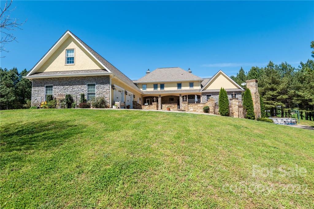 4597 Hickory Nut Ridge Road Granite Falls, NC 28630 - Photo 7 of 48 a front view of a house with a garden