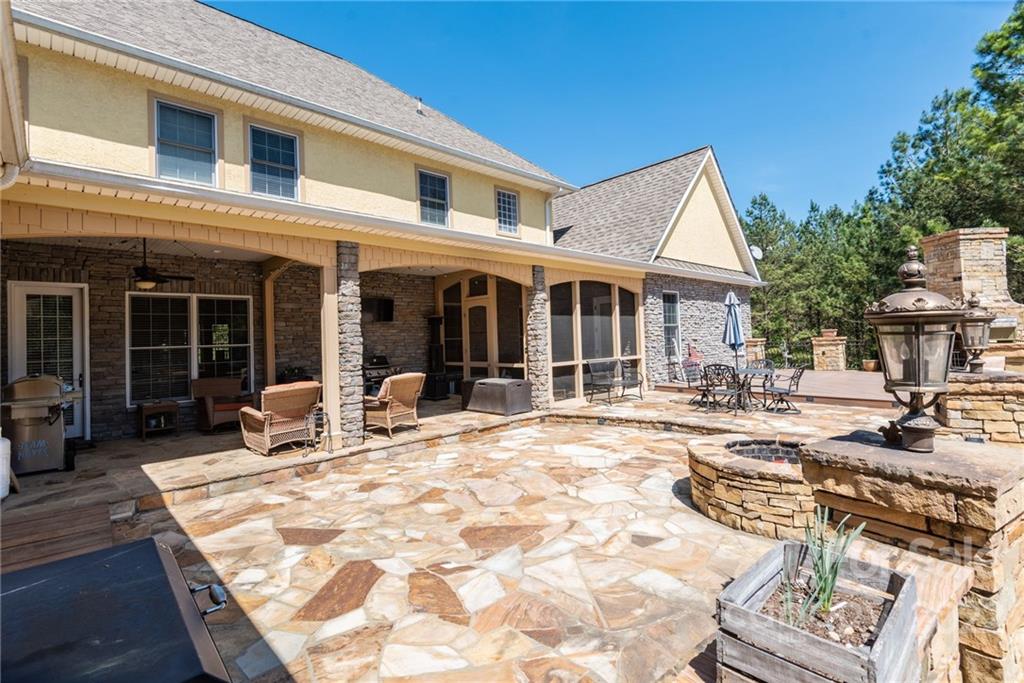 4597 Hickory Nut Ridge Road Granite Falls, NC 28630 - Photo 10 of 48 a view of a house with backyard sitting area and porch