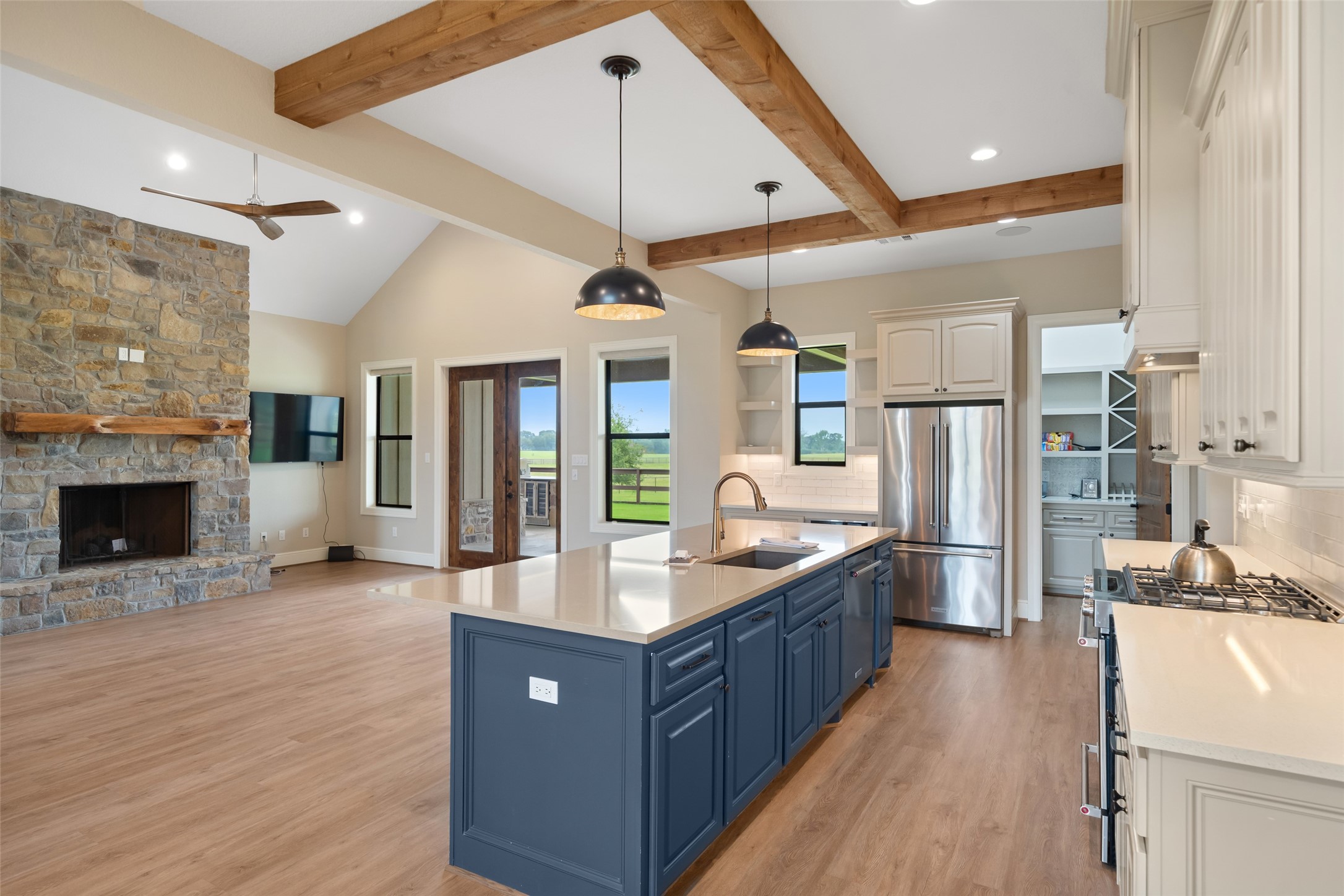 30163 High Spirit Ranch Road Hempstead, TX 77445 - Photo 17 of 49 a large kitchen with stainless steel appliances a large counter top a stove and a refrigerator