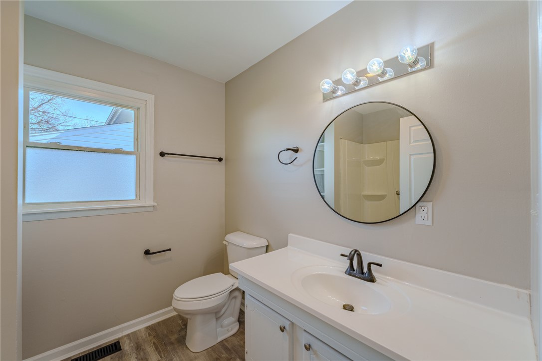 1005 Burt Street Springfield, OH 45505 - Photo 18 of 33 This bright bathroom features a vanity, mirror, and a window for natural light.