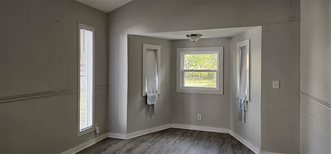 1009 8th Avenue Rock Falls, IL 61071 - Photo 5 of 16 a view of an empty room with wooden floor and a window