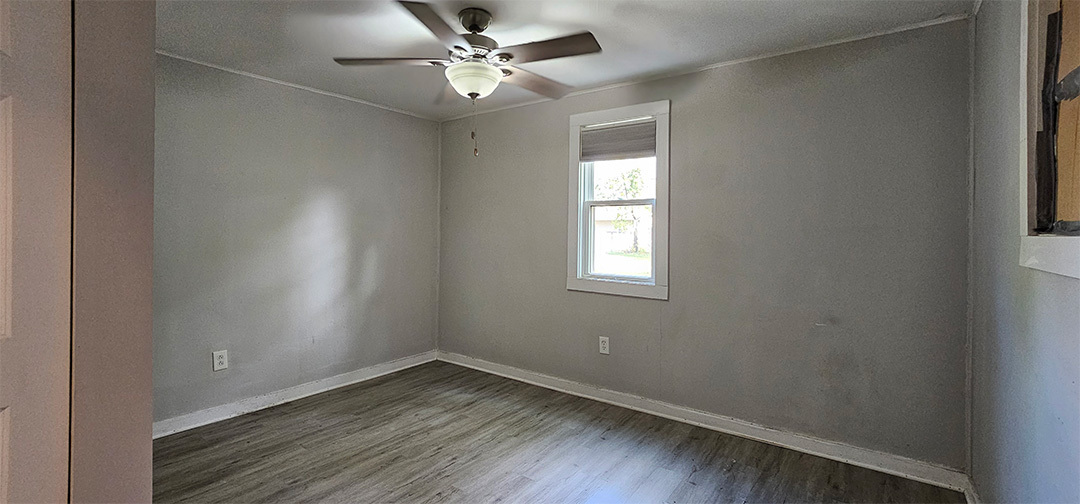 1009 8th Avenue Rock Falls, IL 61071 - Photo 8 of 16 an empty room with a window and wooden floor