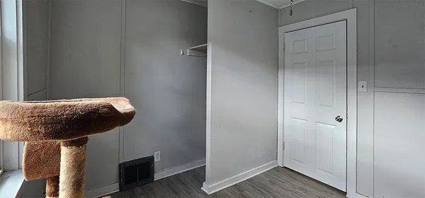 a room with wooden floor and windows