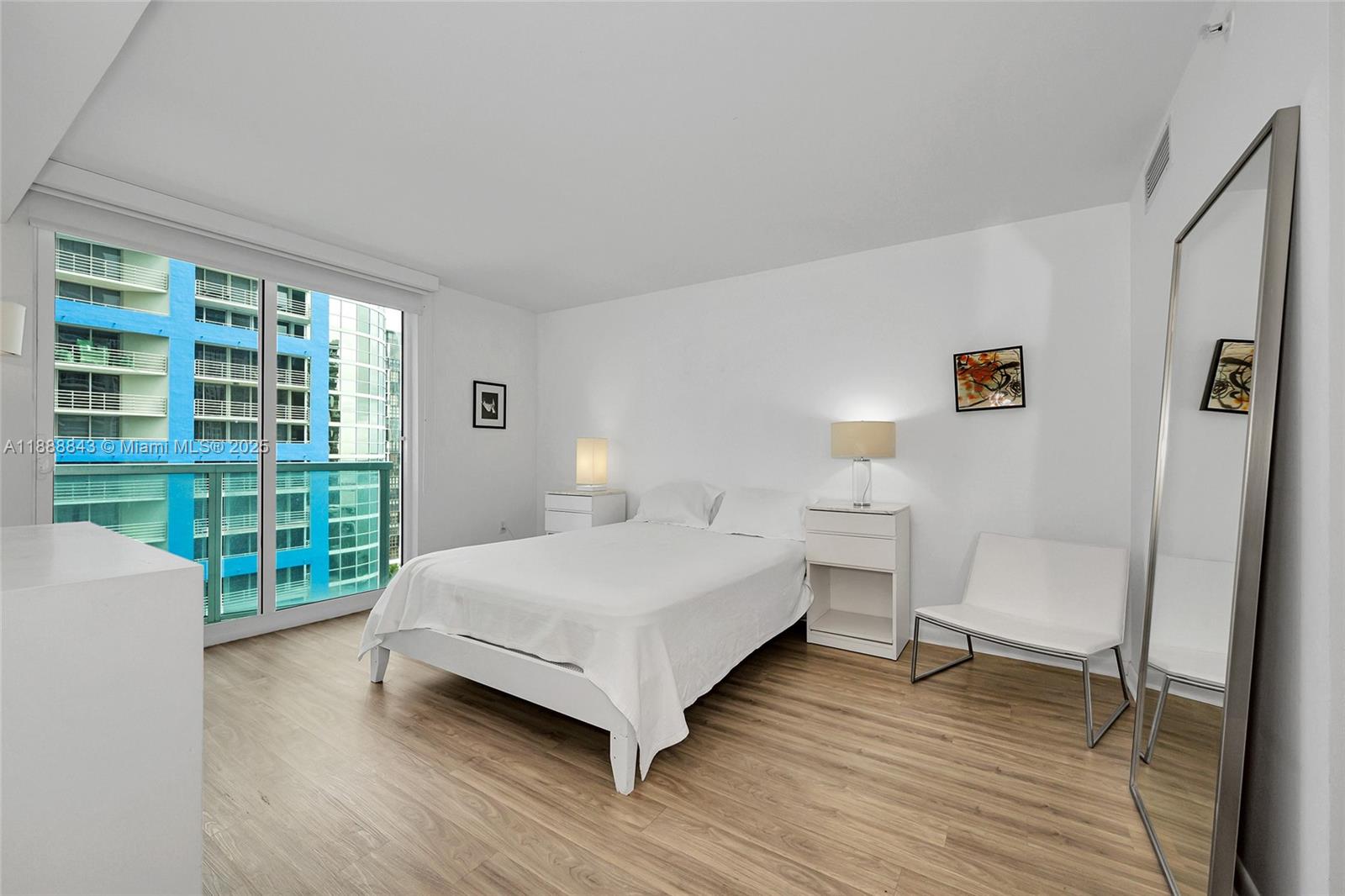 2101 Brickell Avenue, Unit 905 Miami, FL 33129 - Photo 20 of 23 a bedroom with a bed and a chair