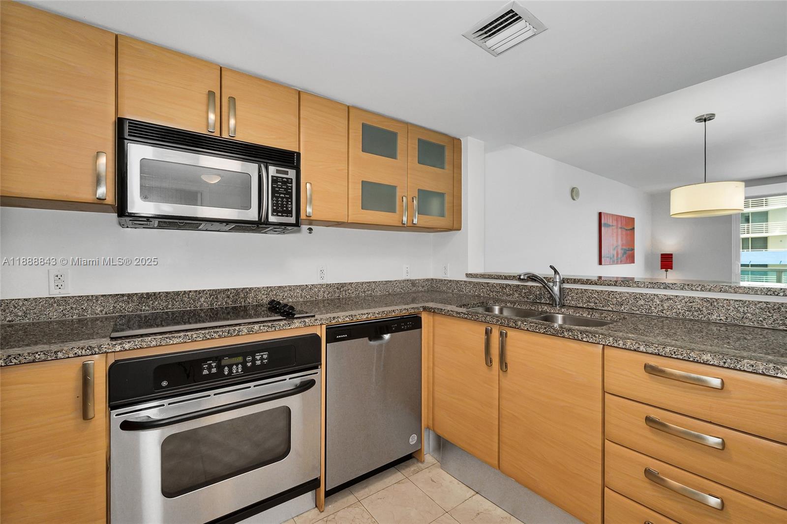 2101 Brickell Avenue, Unit 905 Miami, FL 33129 - Photo 4 of 23 a kitchen with granite countertop cabinets stainless steel appliances and a sink