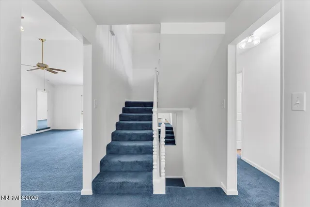 a kitchen with granite countertop a stove a sink and a refrigerator