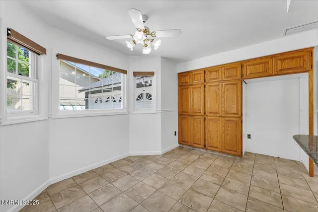 a kitchen with granite countertop a sink and cabinets
