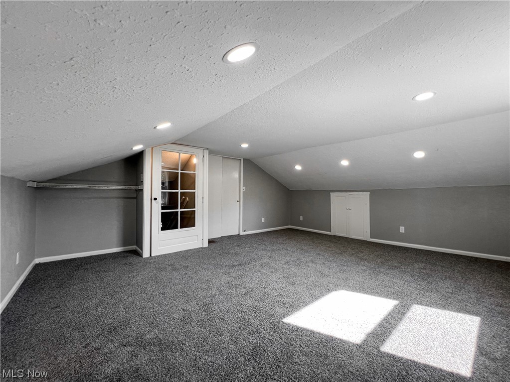 602 West Marshall Road McDonald, OH 44437 - Photo 13 of 19 Bedroom with vaulted ceiling, a textured ceiling, and carpet flooring