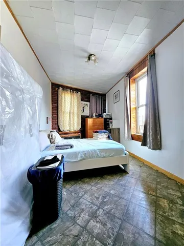 a bedroom with a bed and window