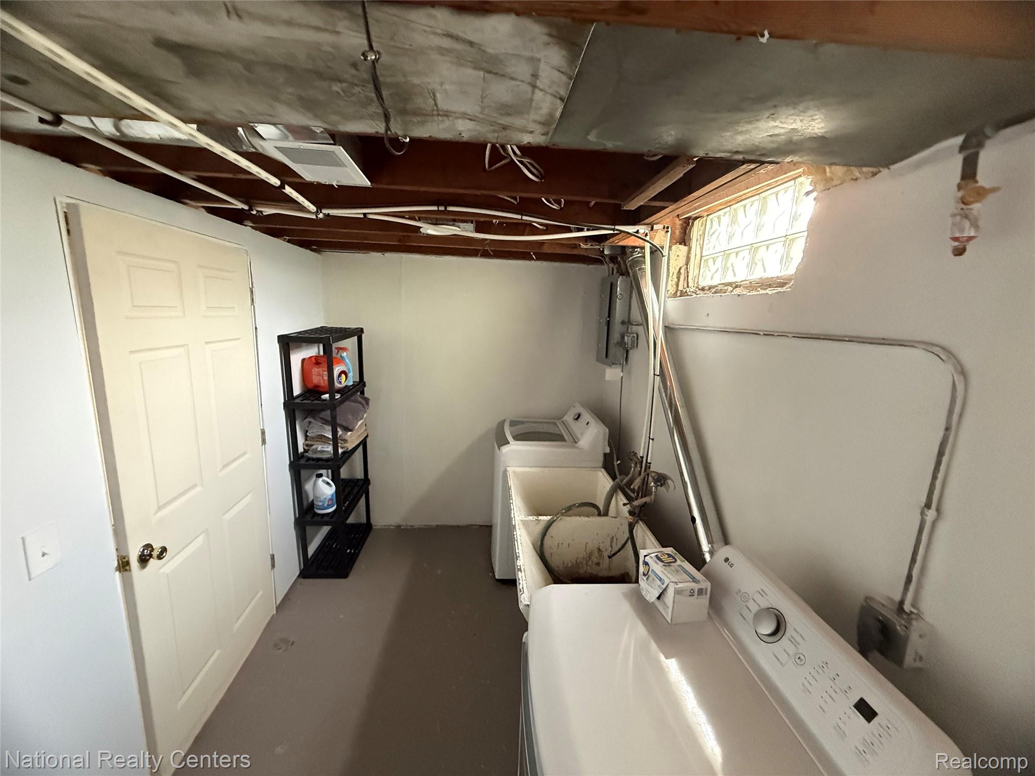9918 Farmington Road Livonia, MI 48150 - Photo 8 of 14 Laundry area with a utility sink and glass block window