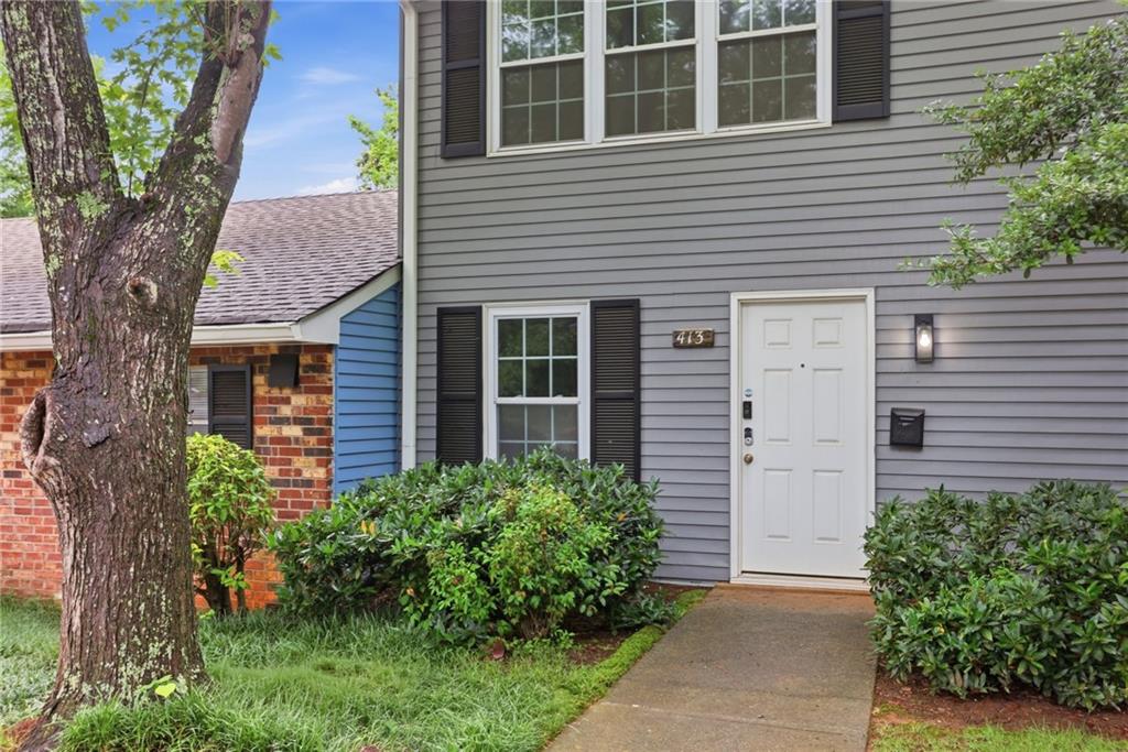 413 Promenade Court Marietta, GA 30064 - Photo 2 of 28 a front view of a house with a garden