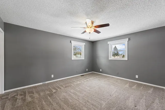 a view of room with a ceiling fan and window