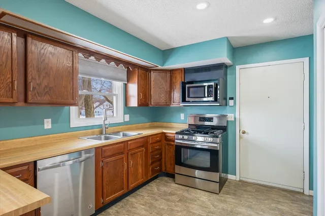 a kitchen that has a sink and a stove