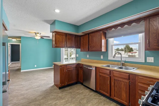 a kitchen with granite countertop a sink and cabinets