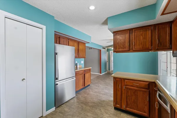 a kitchen with stainless steel appliances granite countertop a refrigerator sink and cabinets