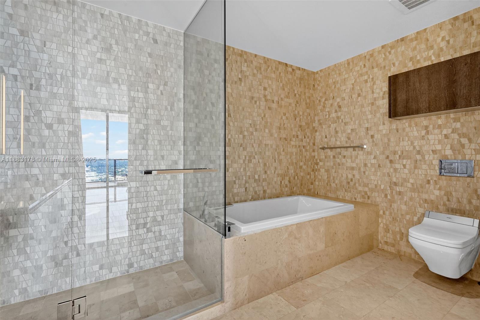 88 Southwest 7th Street, Unit 2402 Miami, FL 33130 - Photo 17 of 38 a bathroom with a bathtub and a shower