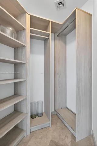 a living room with fireplace and a large window