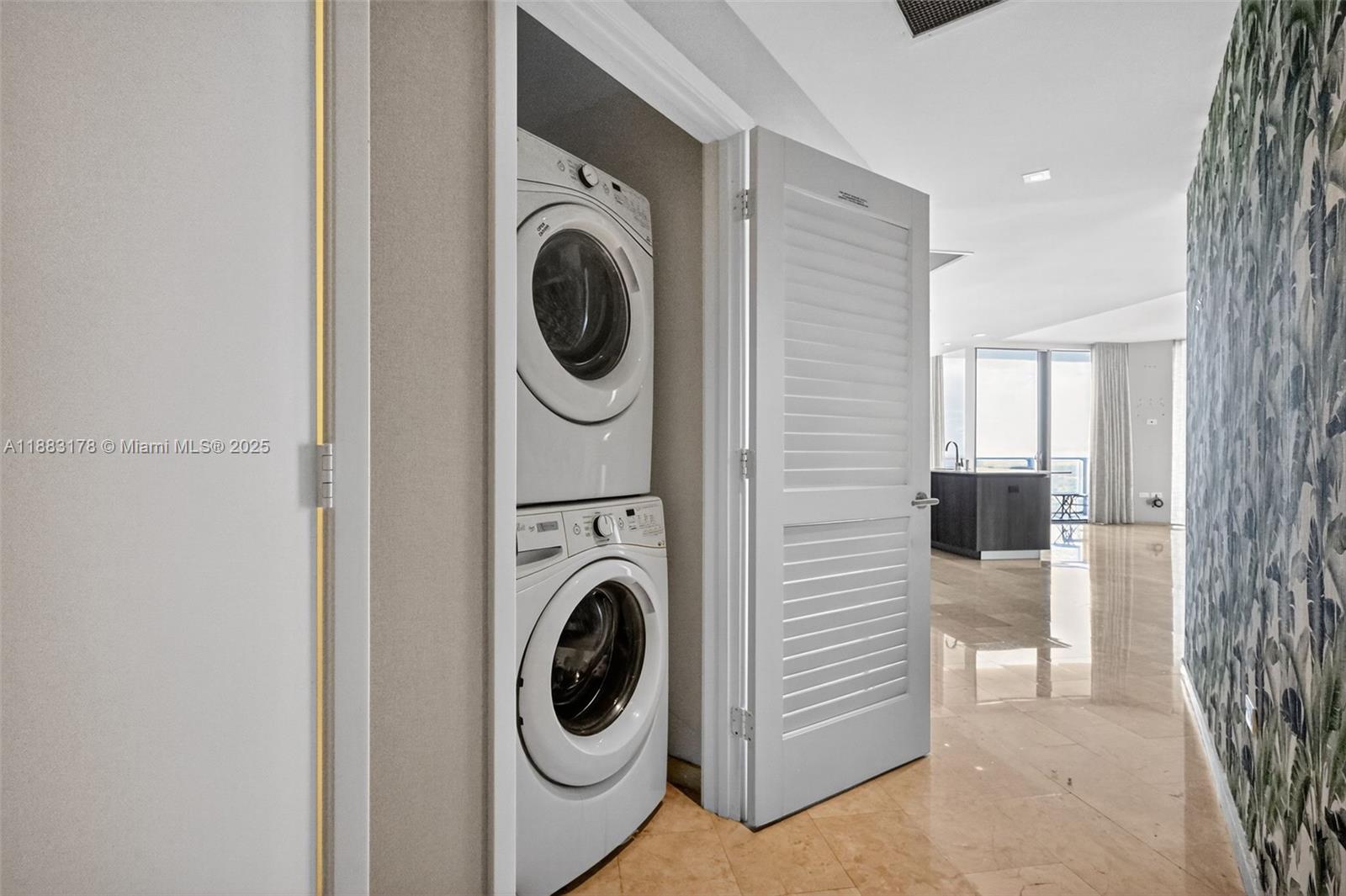 88 Southwest 7th Street, Unit 2402 Miami, FL 33130 - Photo 29 of 38 a view of a hallway with washer and dryer