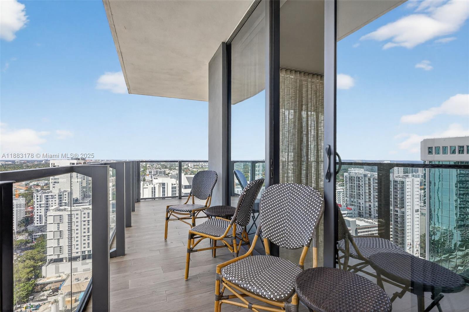 88 Southwest 7th Street, Unit 2402 Miami, FL 33130 - Photo 3 of 38 a view of a workspace with furniture and floor to ceiling window