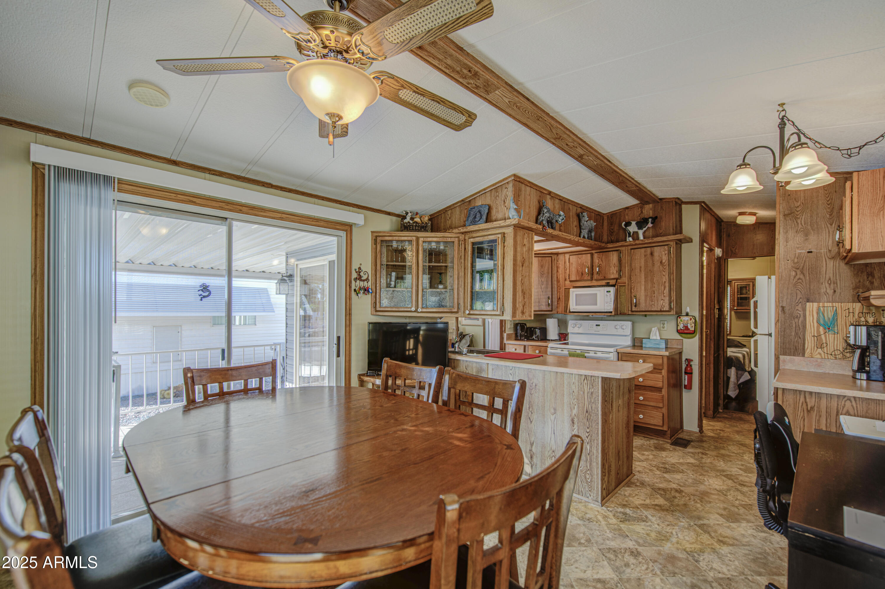 7750 East Broadway Road, Unit 780 Mesa, AZ 85208 - Photo 14 of 44 a view of a dining room with furniture window and wooden floor