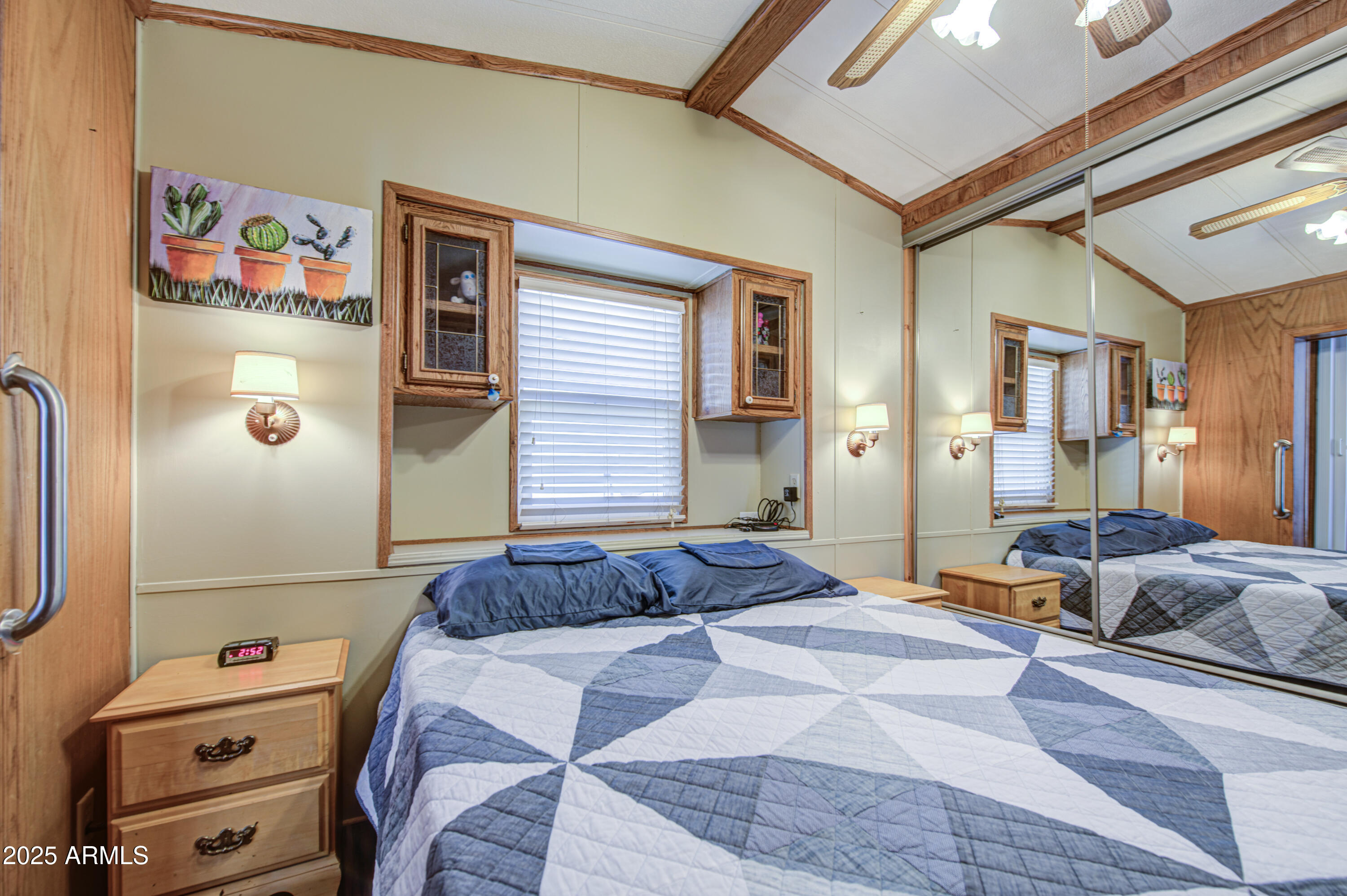 7750 East Broadway Road, Unit 780 Mesa, AZ 85208 - Photo 15 of 44 a bedroom with a bed and wooden floor