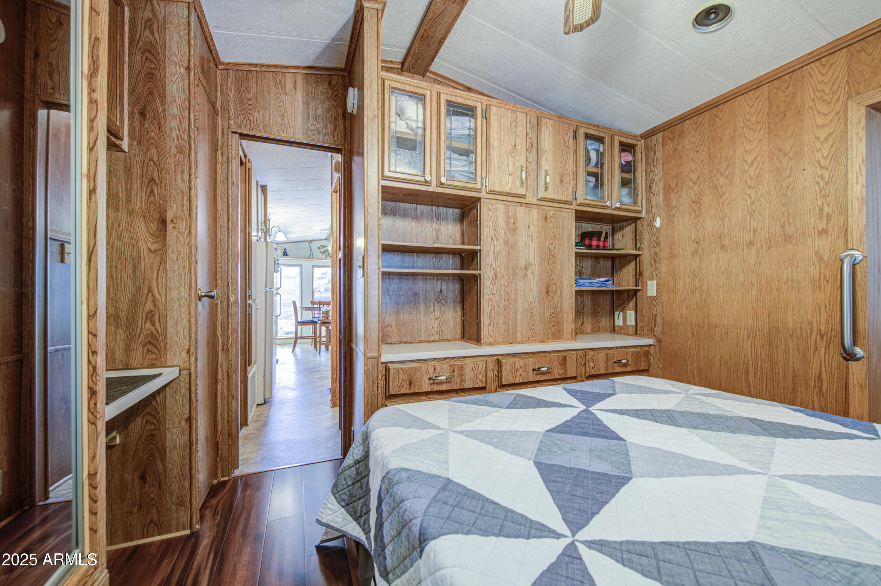 7750 East Broadway Road, Unit 780 Mesa, AZ 85208 - Photo 16 of 44 a bedroom with a bed closet and wooden floor