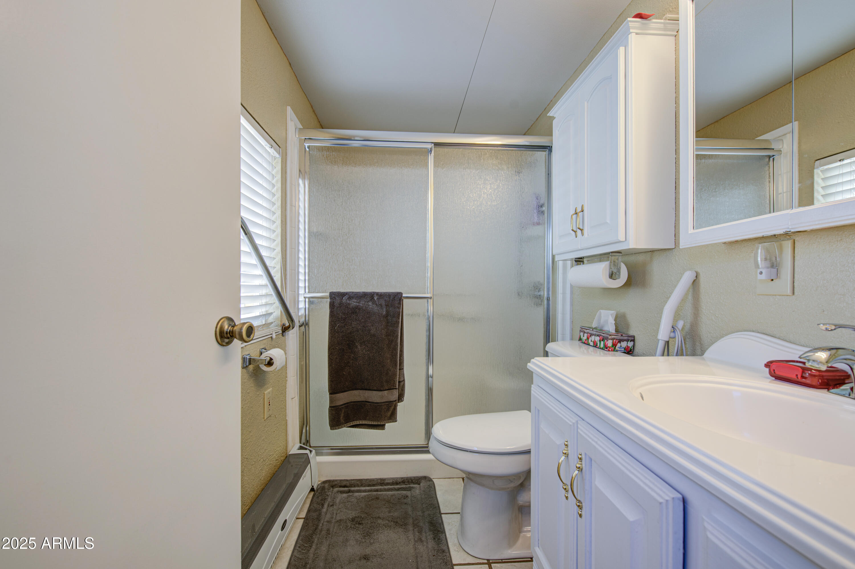 7750 East Broadway Road, Unit 780 Mesa, AZ 85208 - Photo 17 of 44 a bathroom with a sink toilet and shower