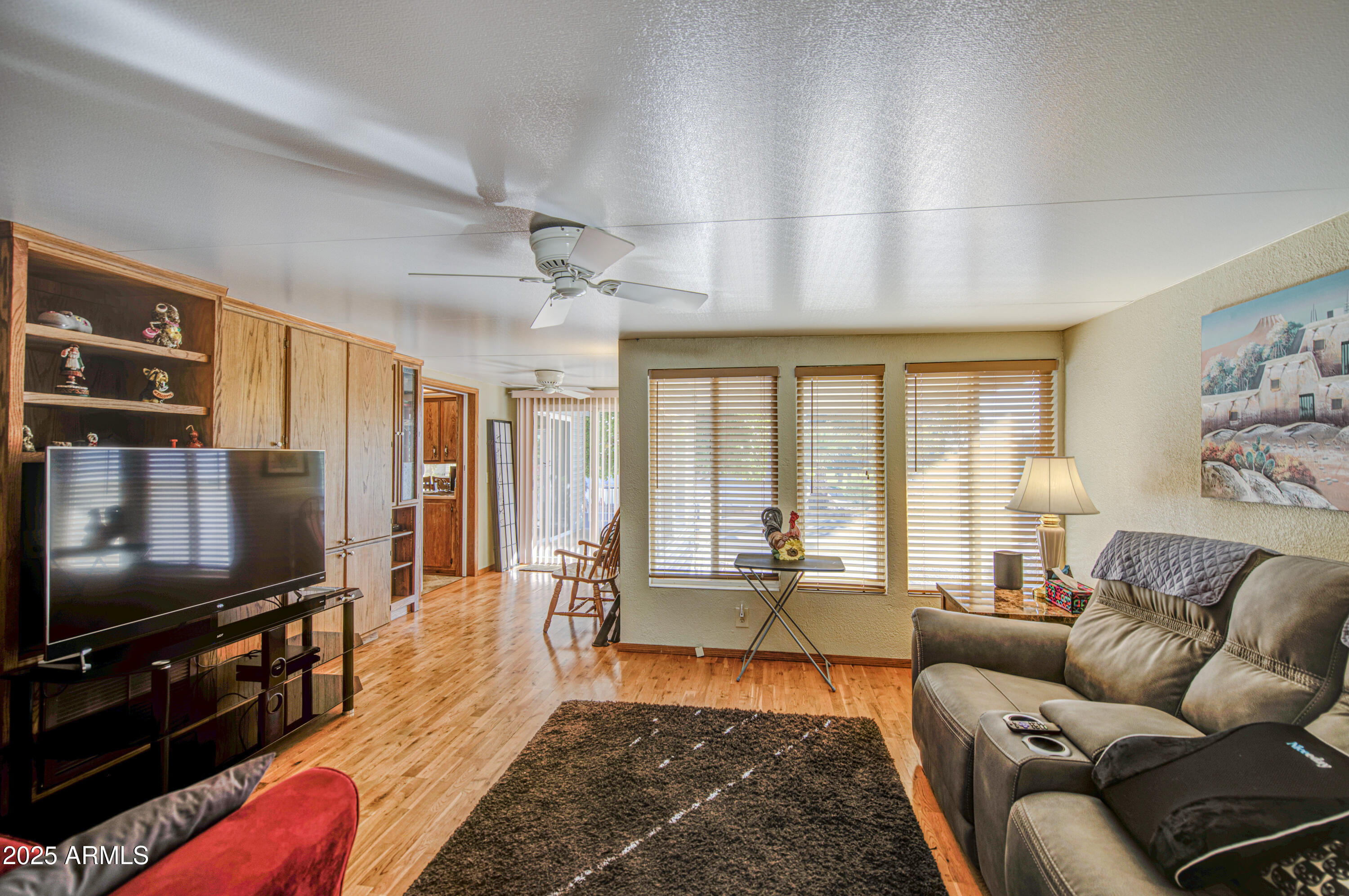 7750 East Broadway Road, Unit 780 Mesa, AZ 85208 - Photo 24 of 44 a living room with furniture and a flat screen tv