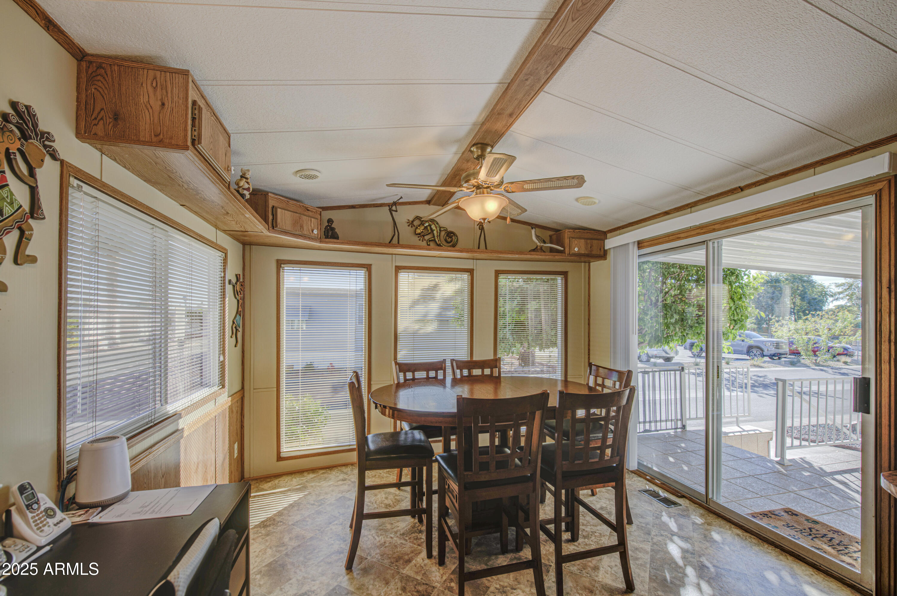 7750 East Broadway Road, Unit 780 Mesa, AZ 85208 - Photo 3 of 44 a view of a dining room with furniture wooden floor and chandelier