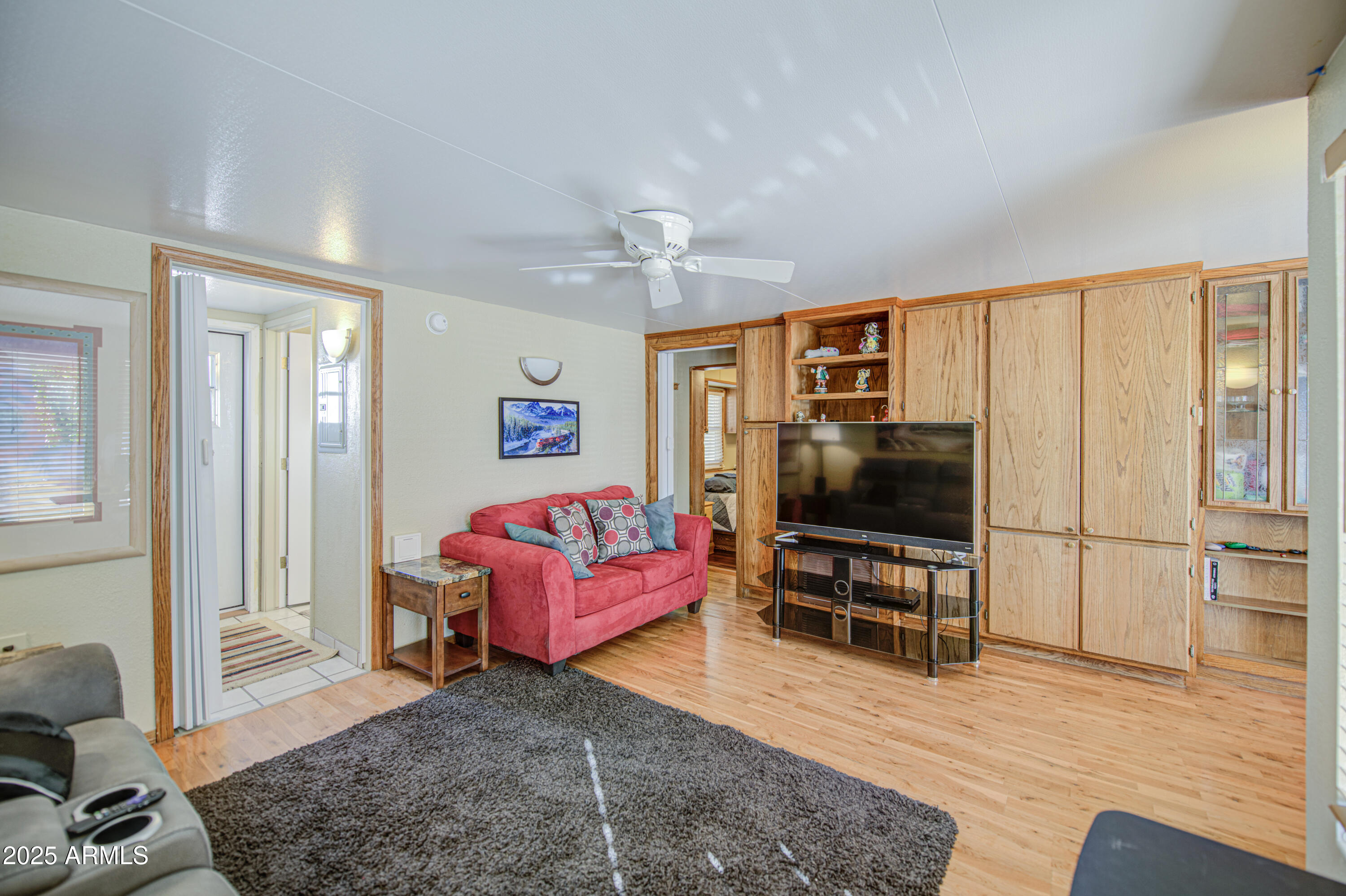 7750 East Broadway Road, Unit 780 Mesa, AZ 85208 - Photo 5 of 44 a living room with furniture and a flat screen tv
