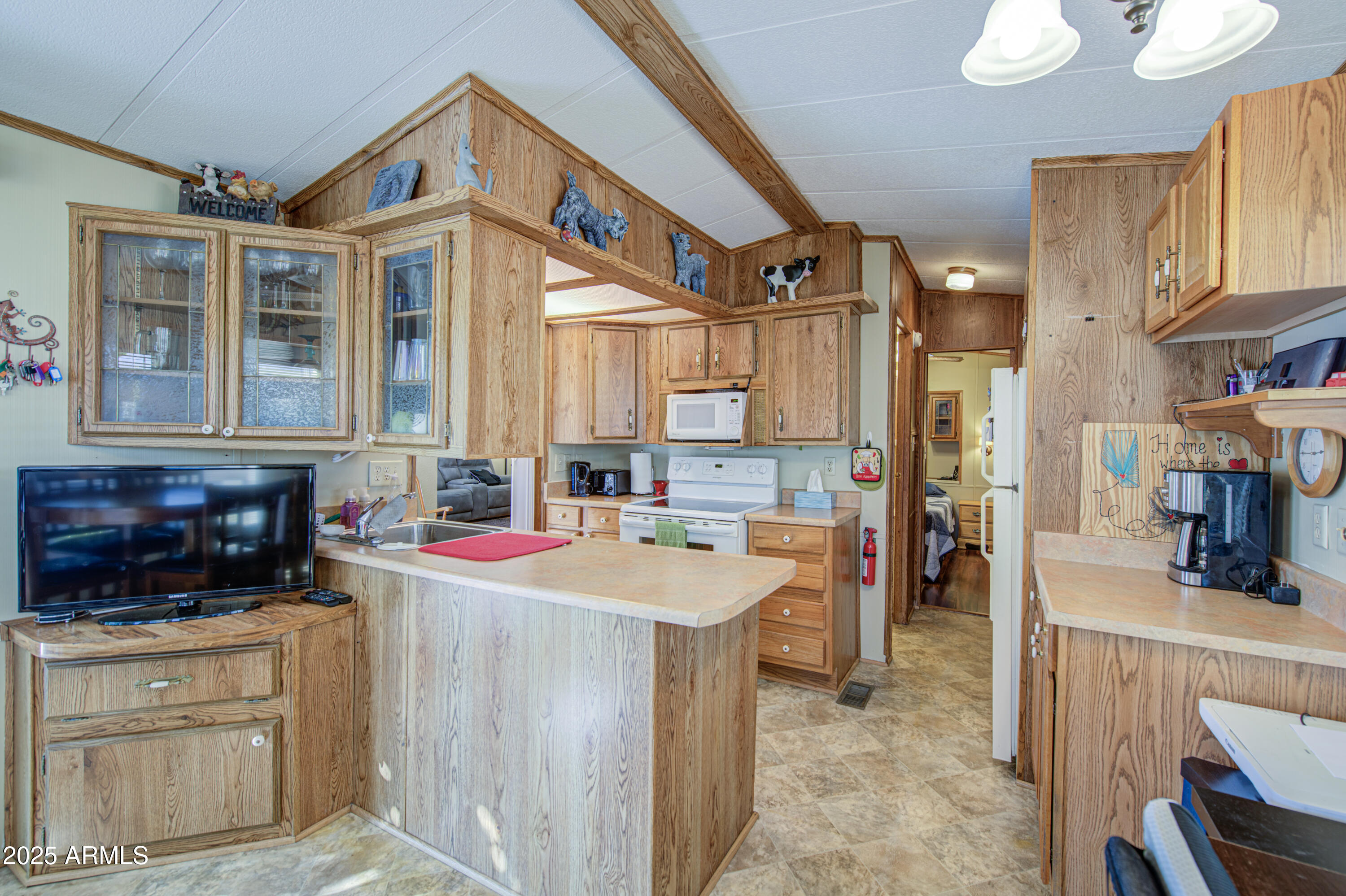 7750 East Broadway Road, Unit 780 Mesa, AZ 85208 - Photo 7 of 44 a kitchen that has a lot of cabinets in it and wooden floors