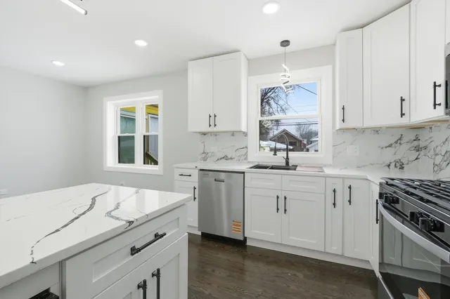 a kitchen with a sink stove and cabinets