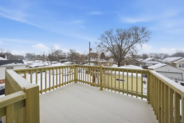 a view of a balcony with wooden fence