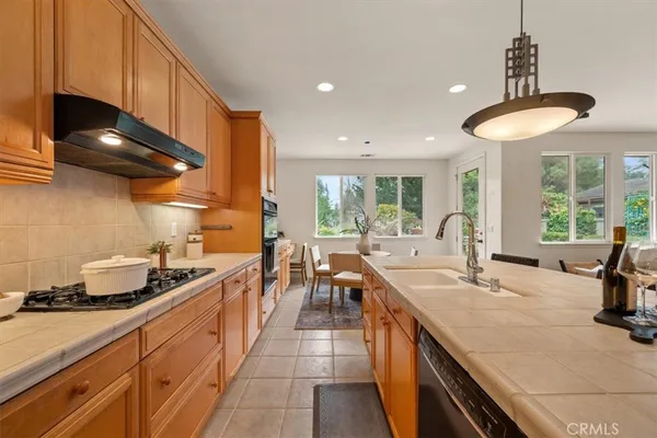 a kitchen with counter top space appliances and windows