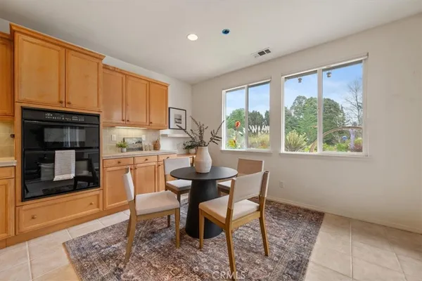 a kitchen with a table chairs and cabinets