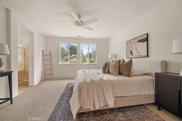 a bedroom with a large bed and a window