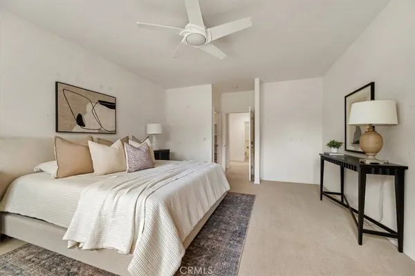 a bedroom with a bed and a painting on the wall