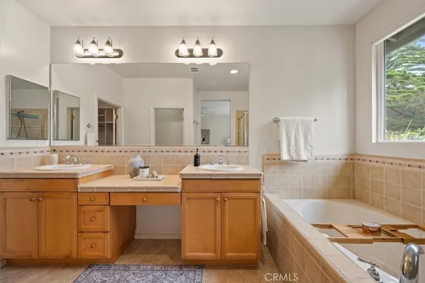 a bathroom with a tub sink and mirror