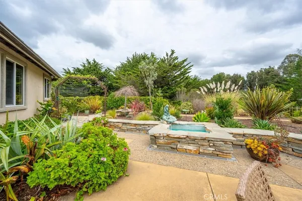 a view of a patio with couches table and chairs and potted plants