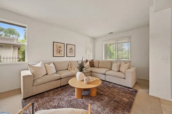 a living room with furniture and a large window