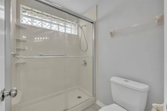 a bathroom with a glass shower door