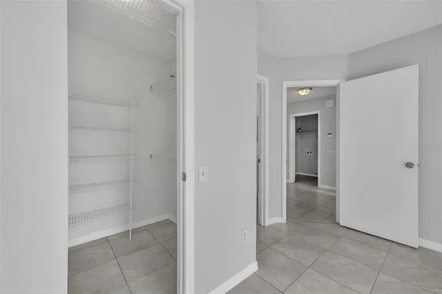 a view of a hallway to rooms