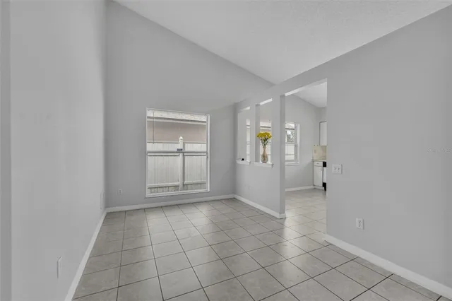 an empty room with entrance and windows