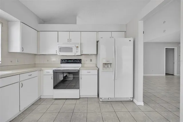 a kitchen with cabinets and a stove top oven