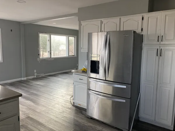 a metallic refrigerator freezer sitting in a kitchen