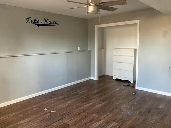 an empty room with wooden floor